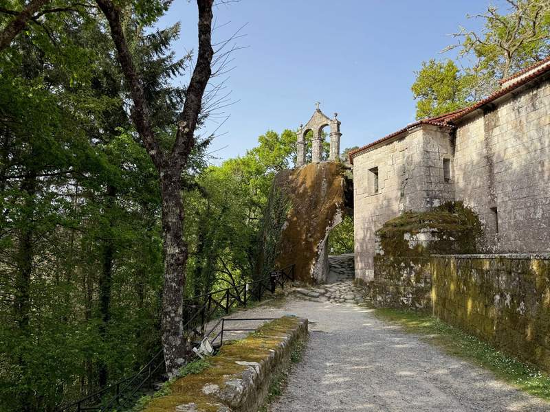 The 15th-century bell tower stands atop a natural rock.