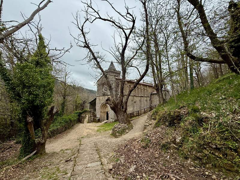 Front of the Monastery of Santa Cristina de Ribas de Sil nestled in the trees.