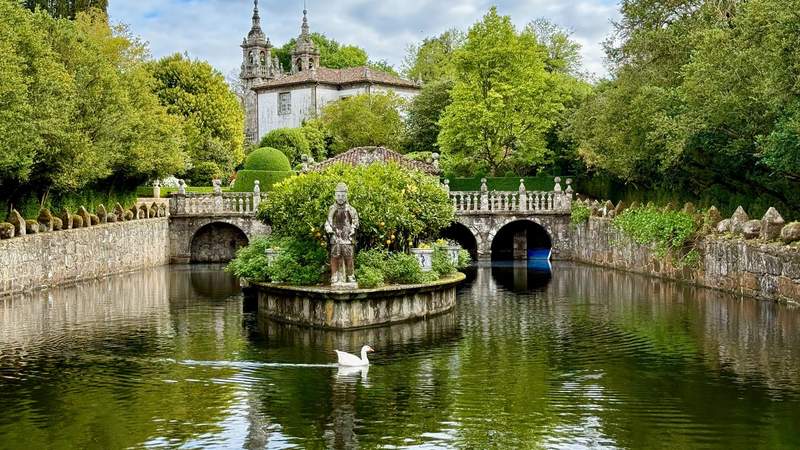 A goose swimming across a beautiful canal in the Pazo de Oca gardens