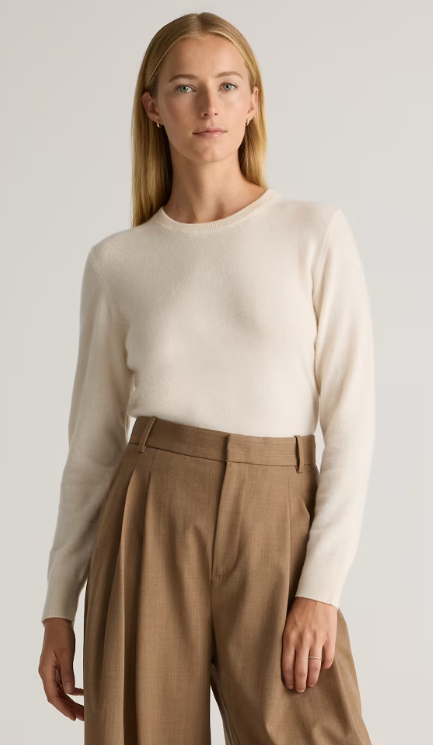 Blond model wearing a cashmere sweater from Quince