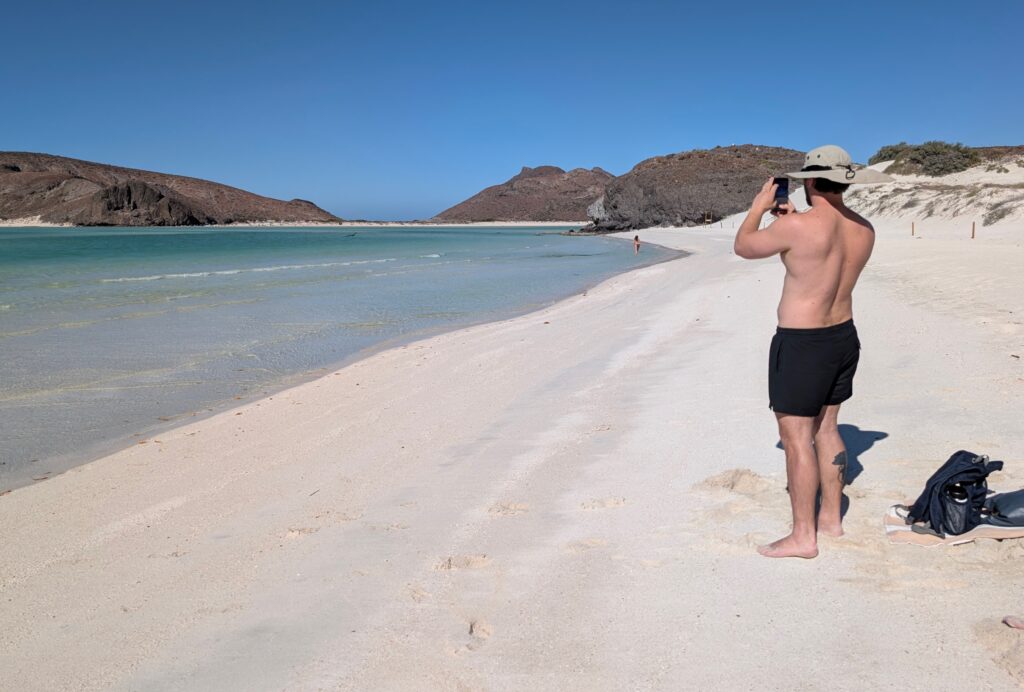 Man taking a photo of the nearly deserted Balandra Bay Beach in La Paz Mexico