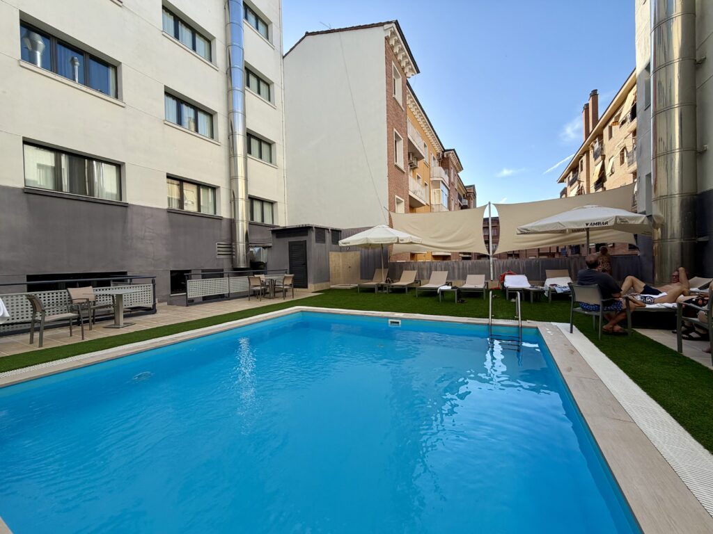 Outdoor pool surrounded by buildings at the Hotel Pedro hotel in Huesca in Aragon, Spain
