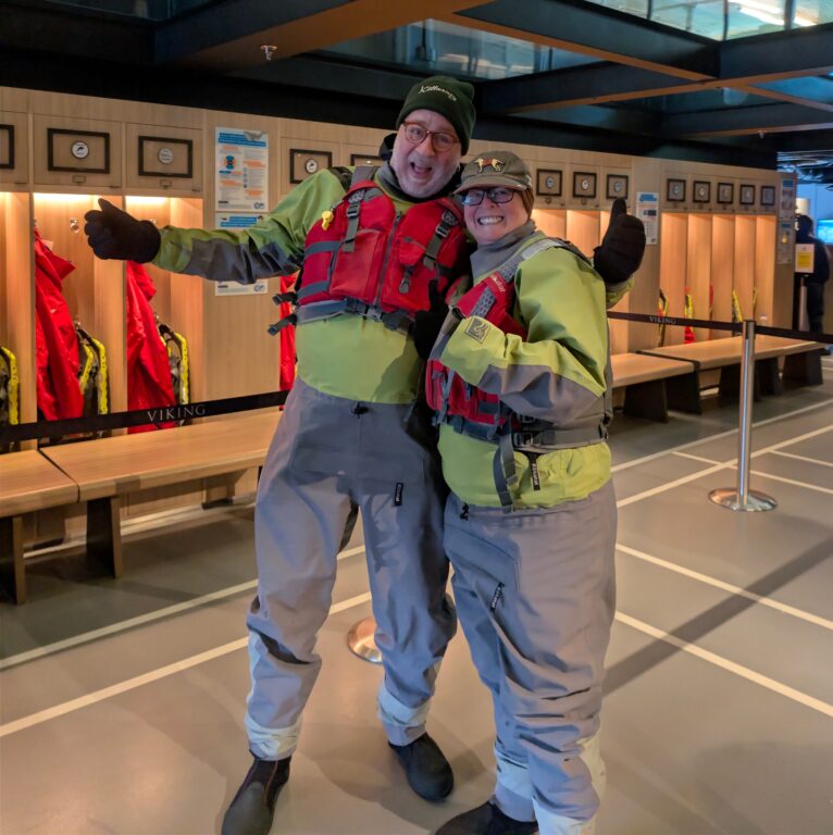 Man and woman dressed up in survival gear for a kayak excursion on a Viking Great Lakes Treasurs cruise