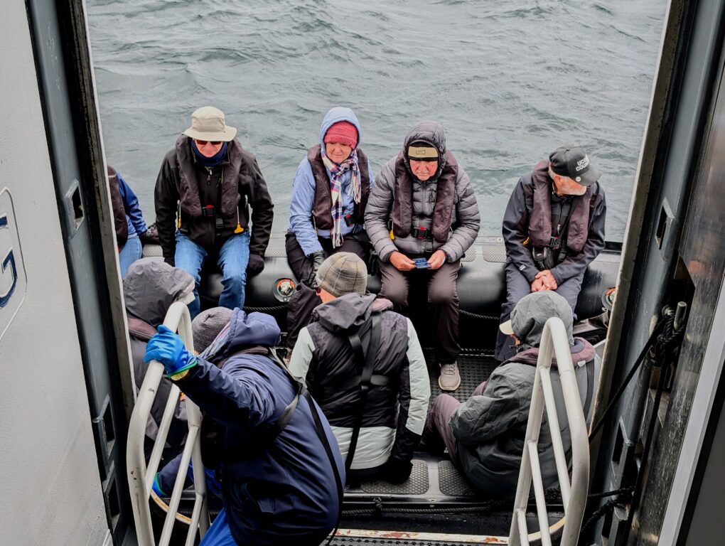 Passengers dressed warmly on a Zodiak rubber skip