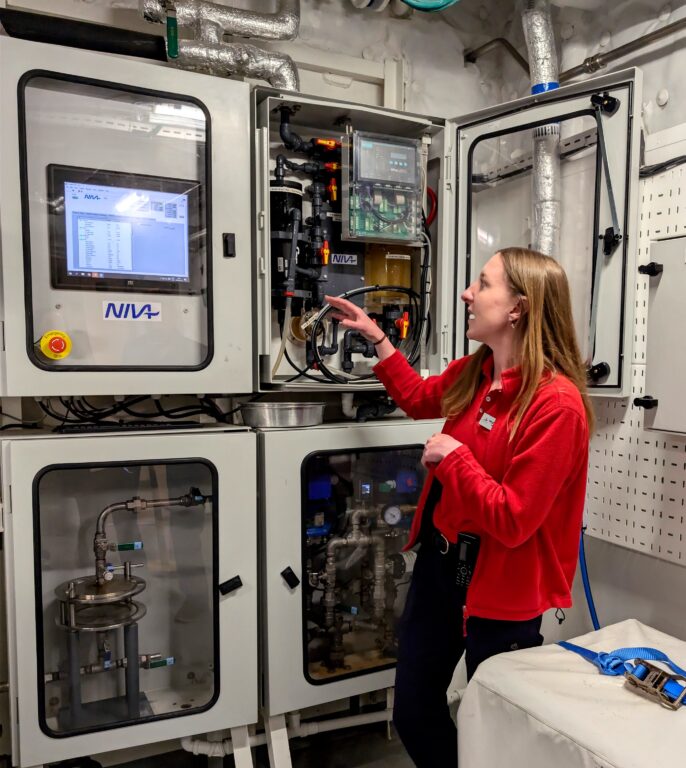 A female scientist shows off "The Ferry Box," which takes water samples every minute of every day on the Viking Polaris cruise ship