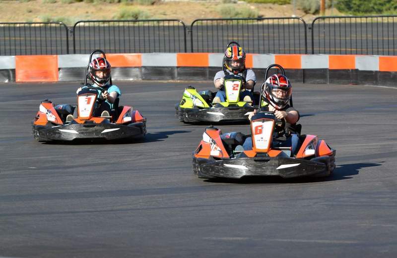 Kids in formula 1 style go karts racing at the Big Bear Speedway.