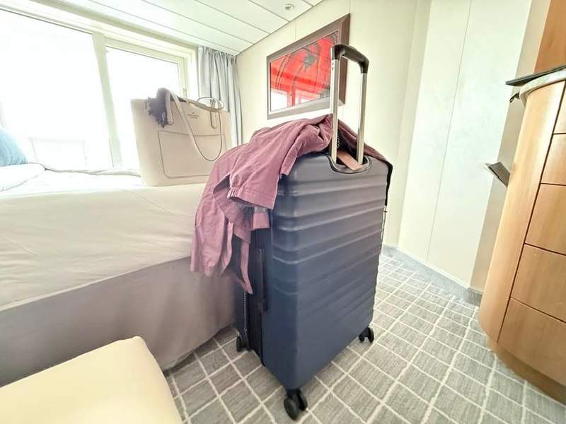 Blue suitcase in a cruise ship stateroom in Alaska.
