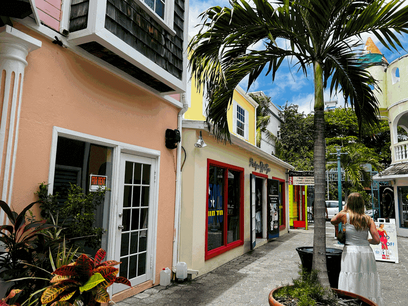 Brightly painted pastel buildings in shades of pink, yellow, and blue lining a street in the historic town of Philipsburg, St. Maarten.