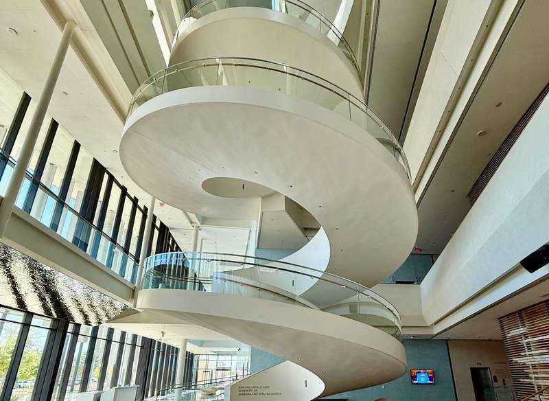 The white circular stairway spirals from lobby to top floor. 