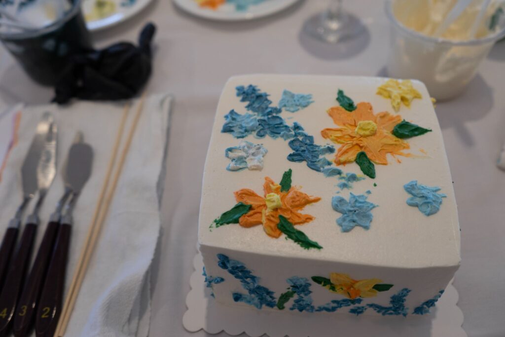 A beautifully decorated cake with thick buttercream frosting from the Happy Little Cakes event at Saint John's Resort