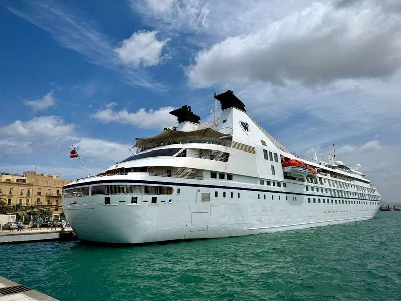 All-suite small cruise ship Windstar Star Legend anchored in a Mediterranean bay.