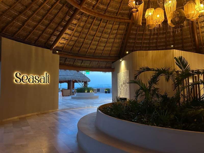 Entrance to Seasalt rooftop restaurant at Almare, a Luxury Collection Resort, Isla Mujeres frames a view of the ocean. 