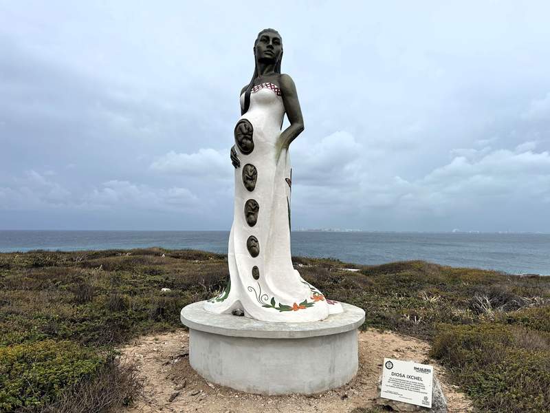 Statue of Ixchel, the goddess of fertility and healing, at Punta Sur with the Caribbean Sea in the background on Isla Mujeres.