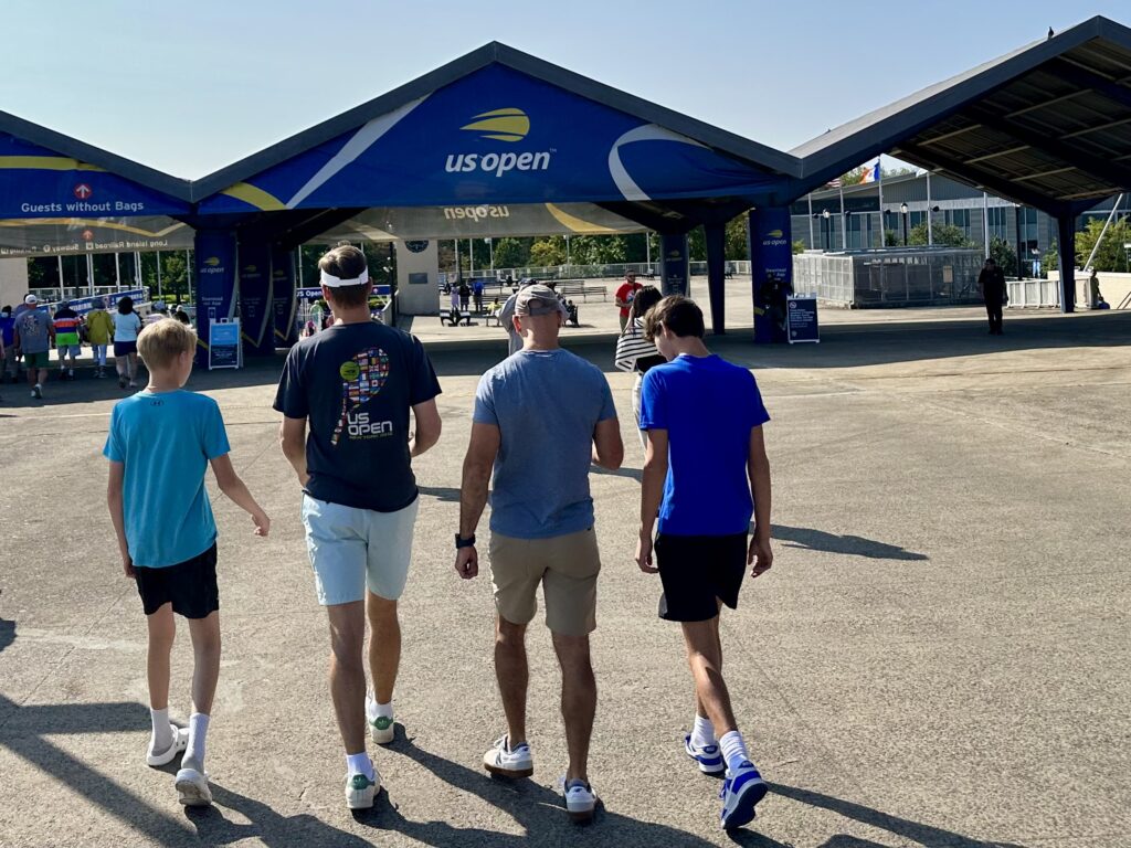 Father with three sons arriving at the US Open tennis tournament