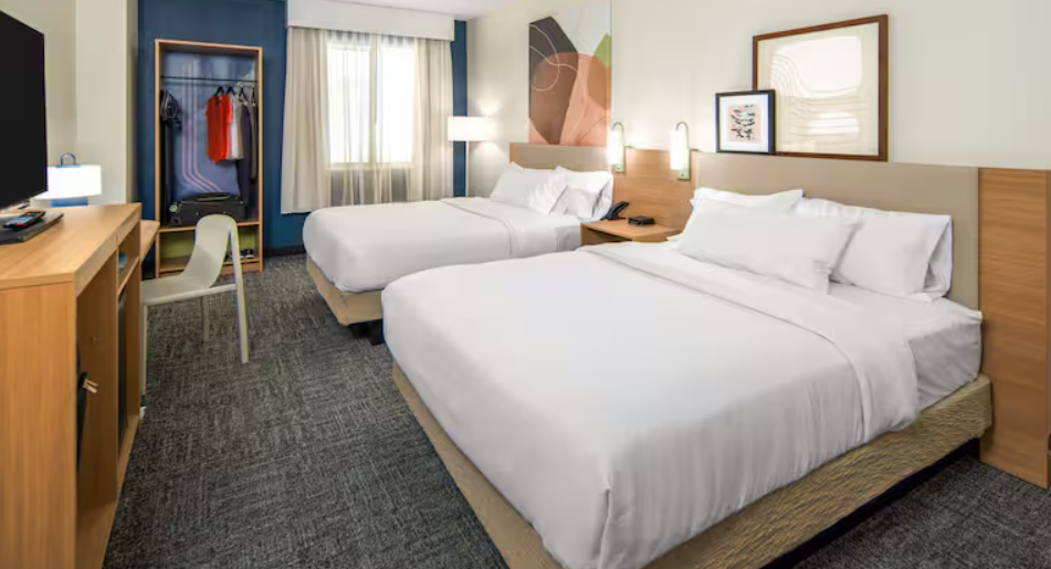 a guestroom with two queen beds in a Spark by Hilton hotel