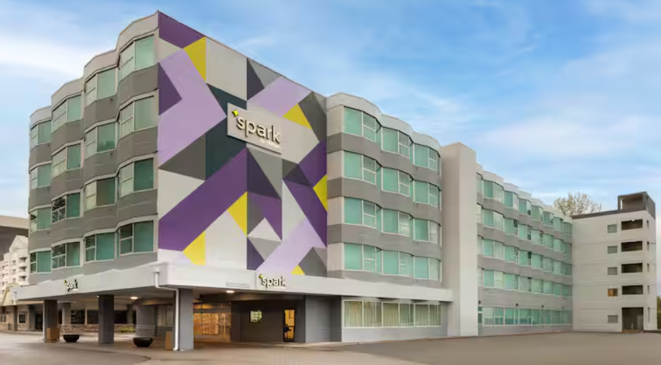 The purple and white facade of the Spark by Hilton Seattle Airport
