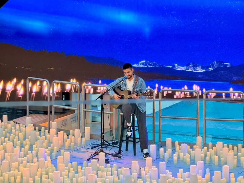 An intimate concert performance in The Dome, illuminated by candlelight and overlooking the sea.