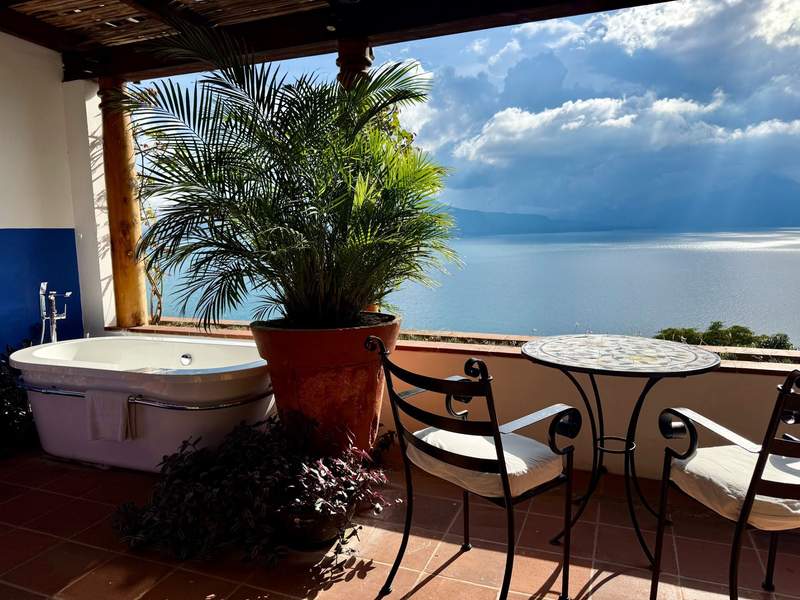 Outdoor bathtub on a private terrace overlooking Lake Atitlan and volcanoes at Casa Palopo Guatemala