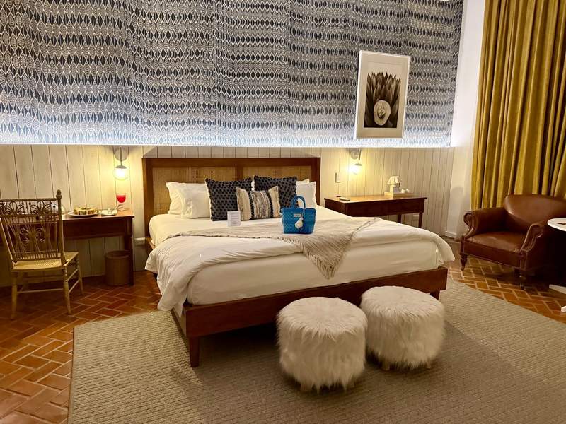 Boutique luxury hotel room at Villa Bokeh featuring handwoven Guatemalan textiles and local artwork