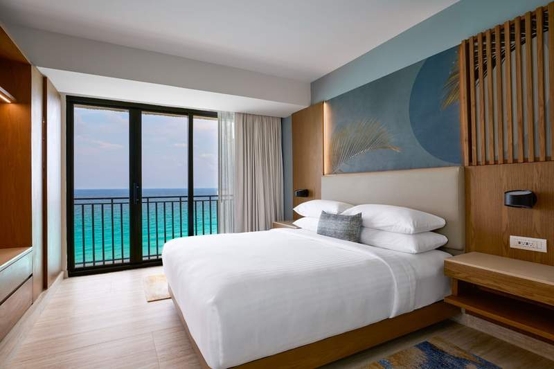 Hotel bed in a room with an ocean view