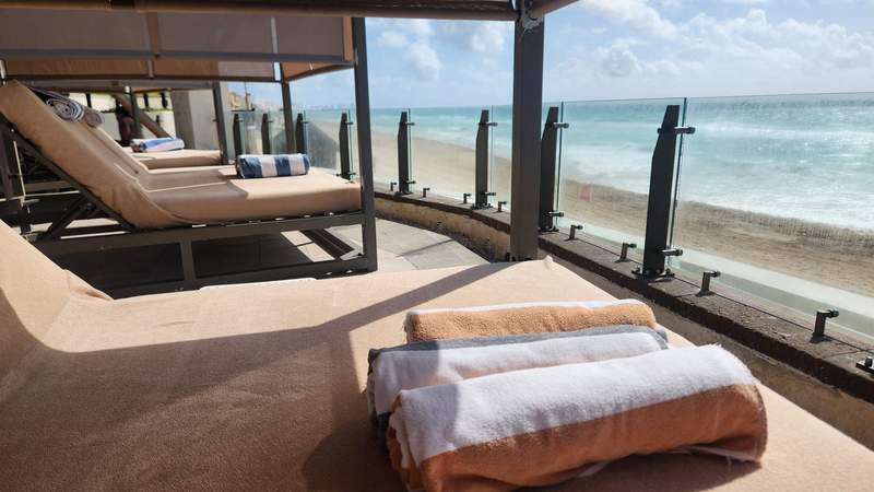 A row of pool cabanas with towels