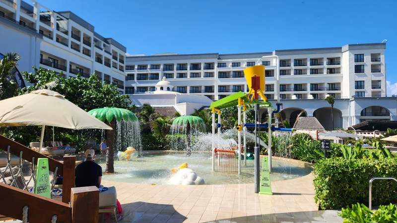 A water splash pad with colorful play equipment
