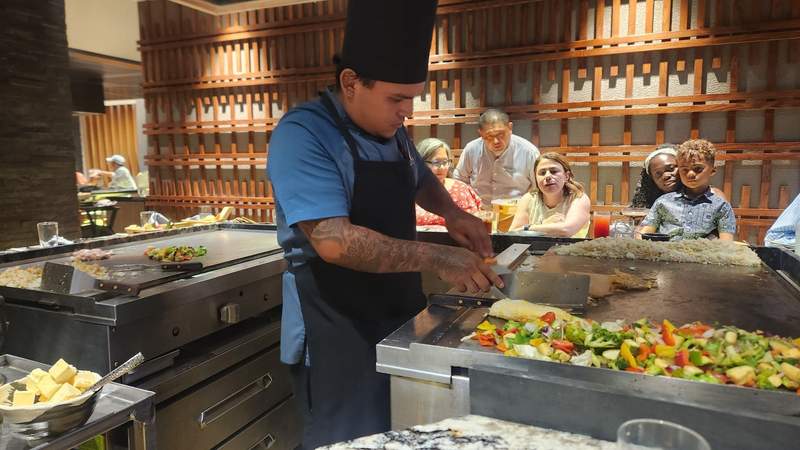 Chef prepares food on two grills