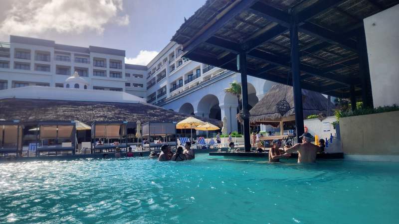 Swimming pool with a swim-up bar and cabanas