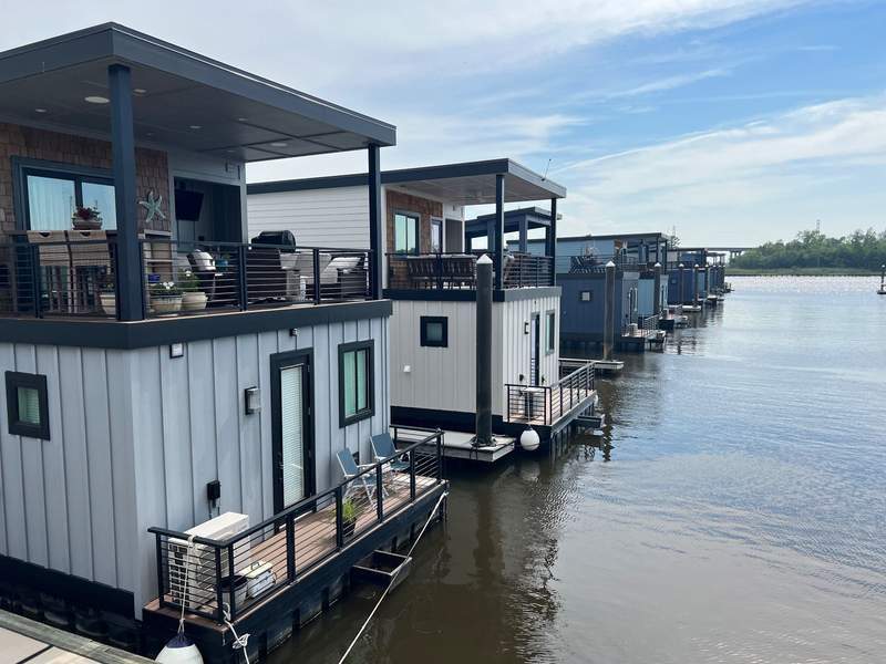 Two-story houseboats sitting on the Cape Fear River.