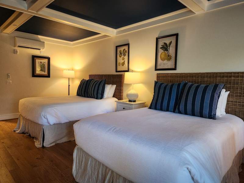 Boutique hotel guest room with bright white linens