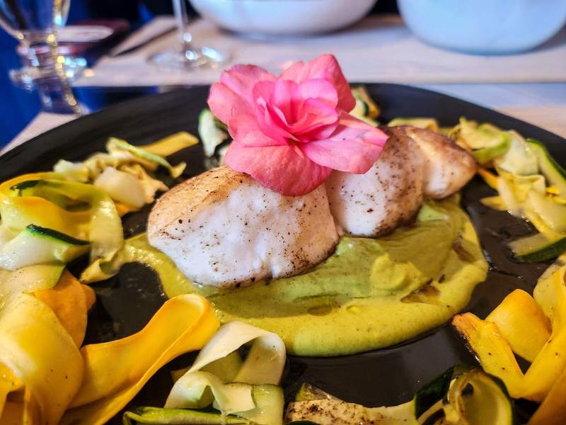 Gourmet seared scallops served with fresh zucchini ribbons at Partake restaurant 