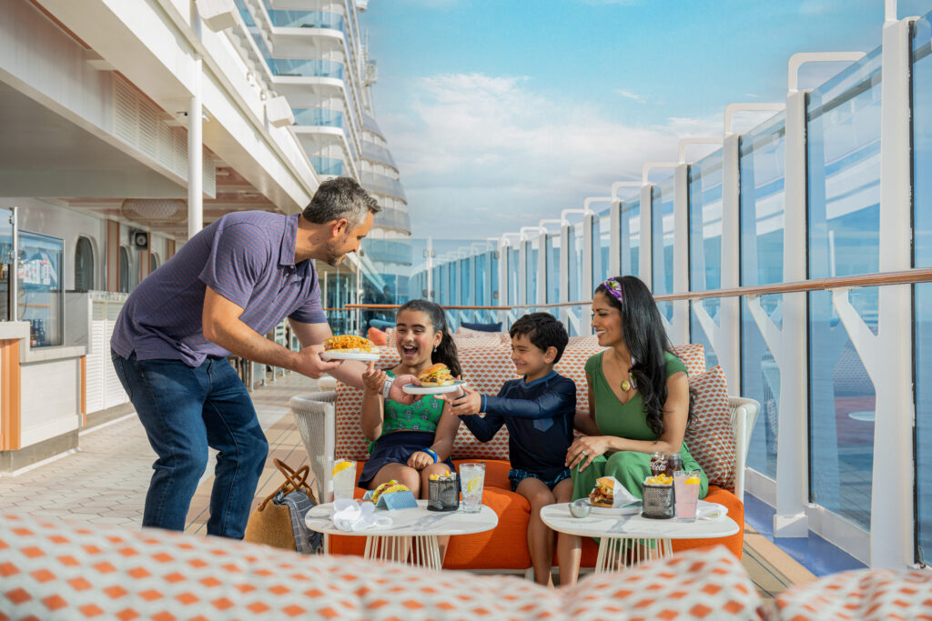 A family enjoying a meal together on the deck of a Princess Cruise Line ship.