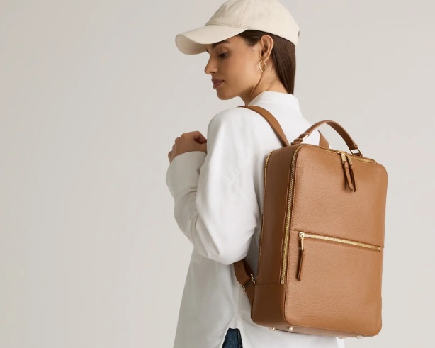 Woman wearing an elegant Quince backpack