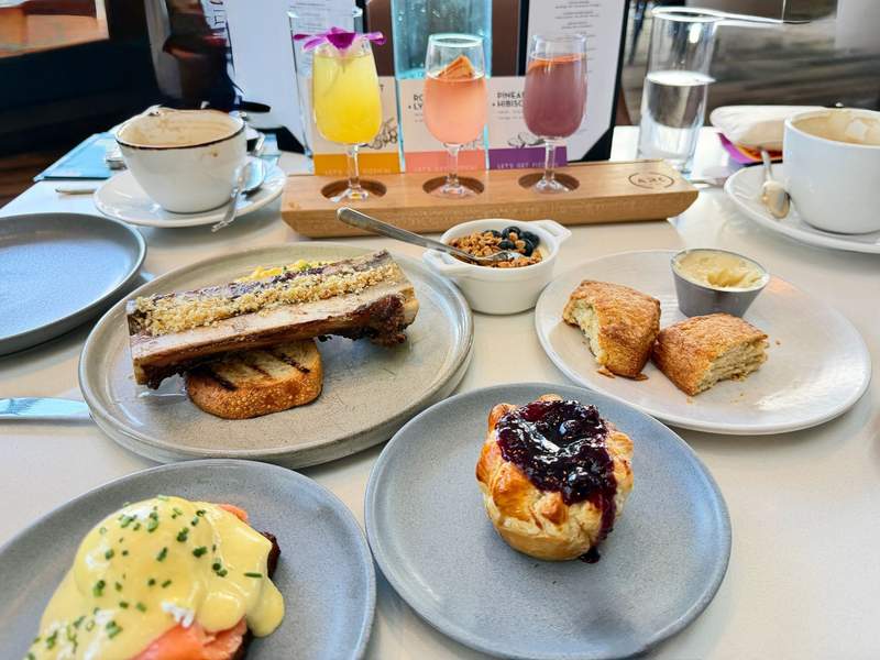 Fairmont Waterfront Vancouver brunch menu items at Arc: homemade biscuits with honey butter, bone marrow, scone with jam, salmon benedict.