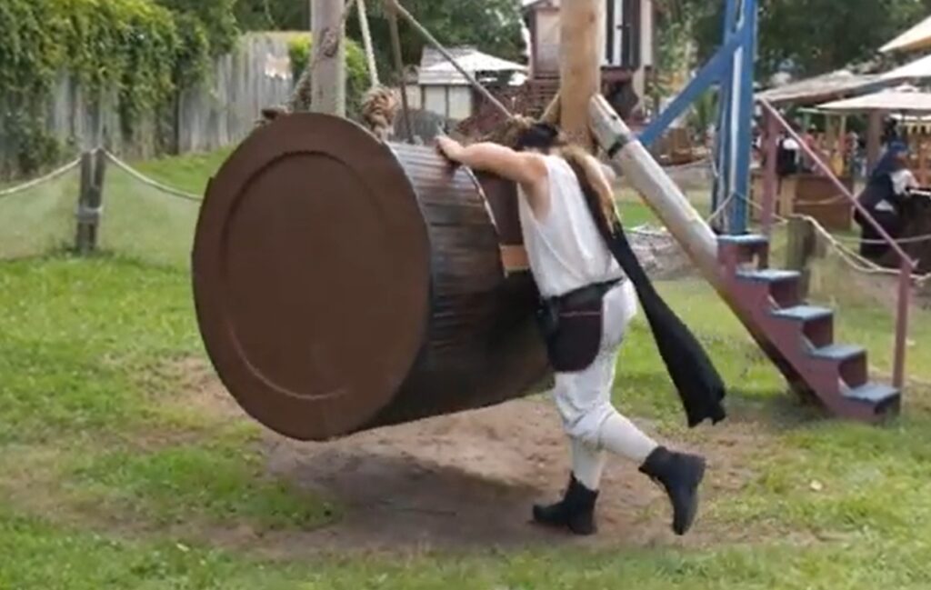 man pushing a human-powered barrel ride at the Bristol Renaissance Faire