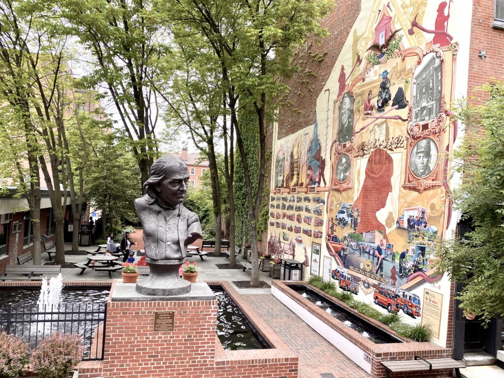 Girard Fountain Park in Philadelphia features bust of Benjamin Franklin and a mural
