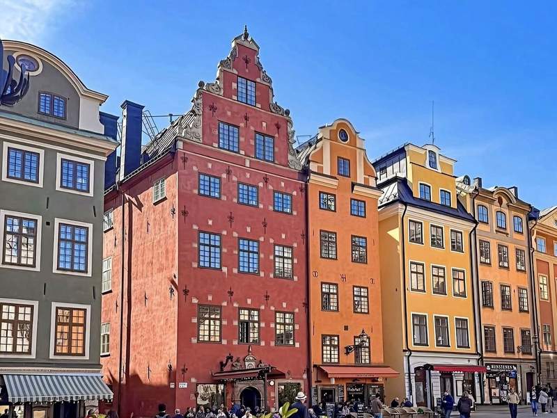 Colorful historic buildings lining Stortorget square in Stockholm’s Gamla Stan.