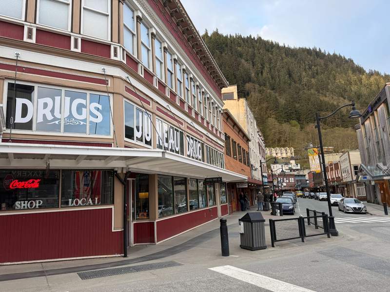 Walkable historic downtown street in Juneau lined with colorful Gold Rush era buildings, local shops, galleries, and mountain views.