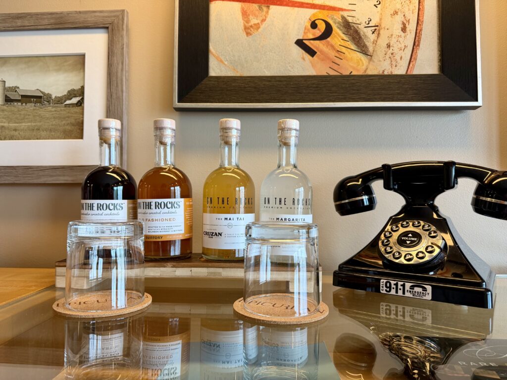 Bottles of pre-mixed cocktail and an antique black phone at the Epicurean Hotel in Tampa, Florida