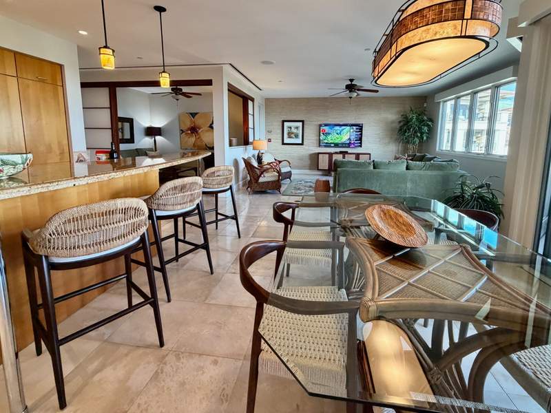 Open-concept kitchen, bar seating and living room at a Wailea Beach Villas residence