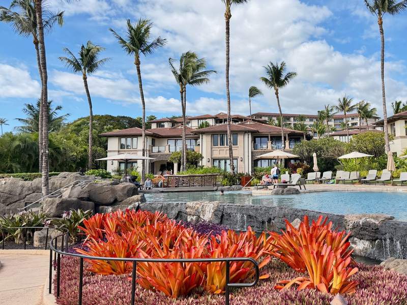 Family pool with lava rock waterfall and tropical landscaping at Wailea Beach Villas