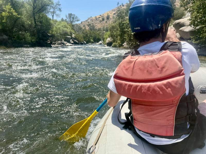 Author’s son paddling in front of raft on Kern River.