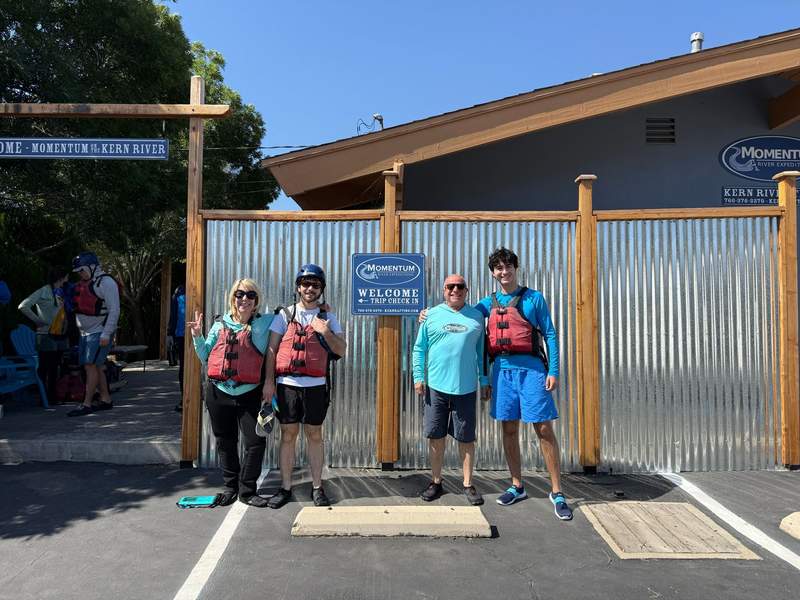Author’s family posing in front of building with life vests and helmets.