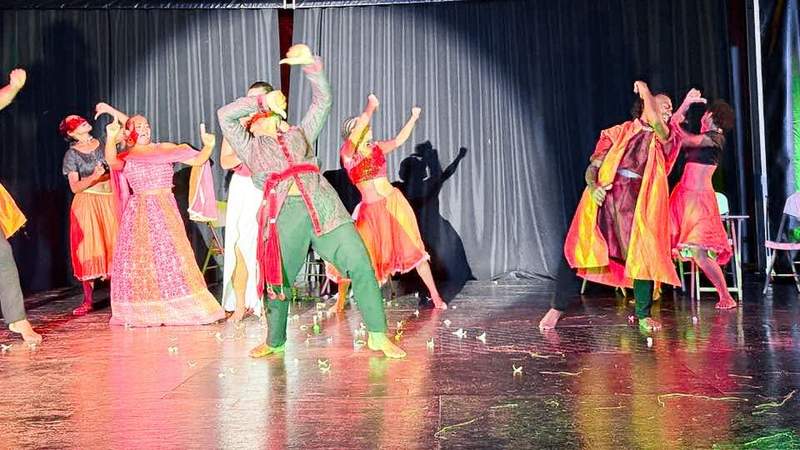 Performers in colorful costumes dancing at VOU Hub