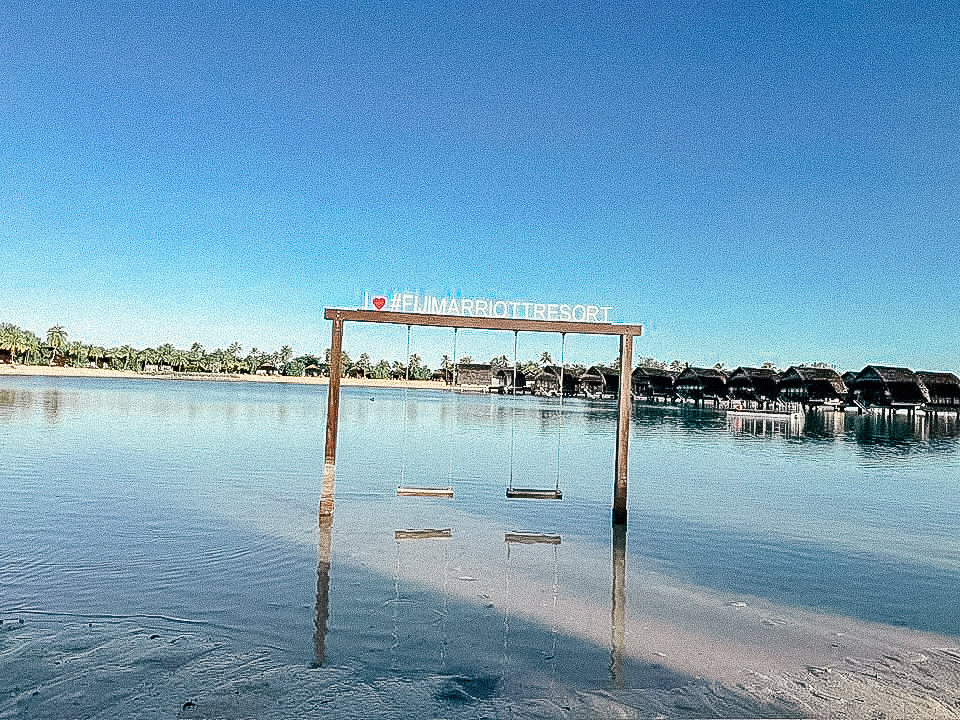 I heart Fiji Marriott Resort sign in the middle of a lagoon with swings