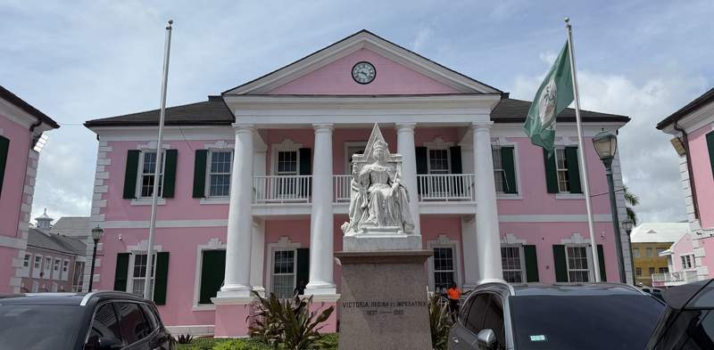 Parliament Square in downtown Nassau Bahamas featuring pink colonial government architecture and the historic Queen Victoria statue.