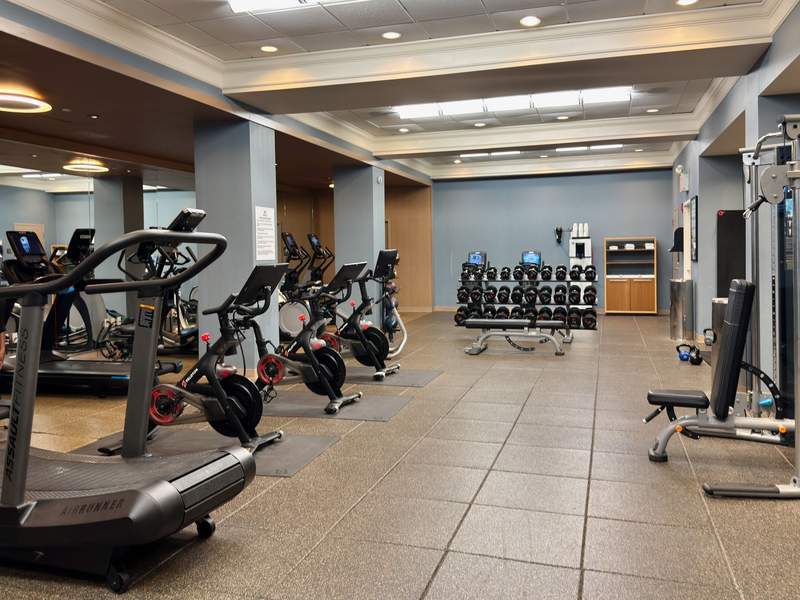 Free weights, Peleton bikes and cardio equipment in spacious hotel gym.