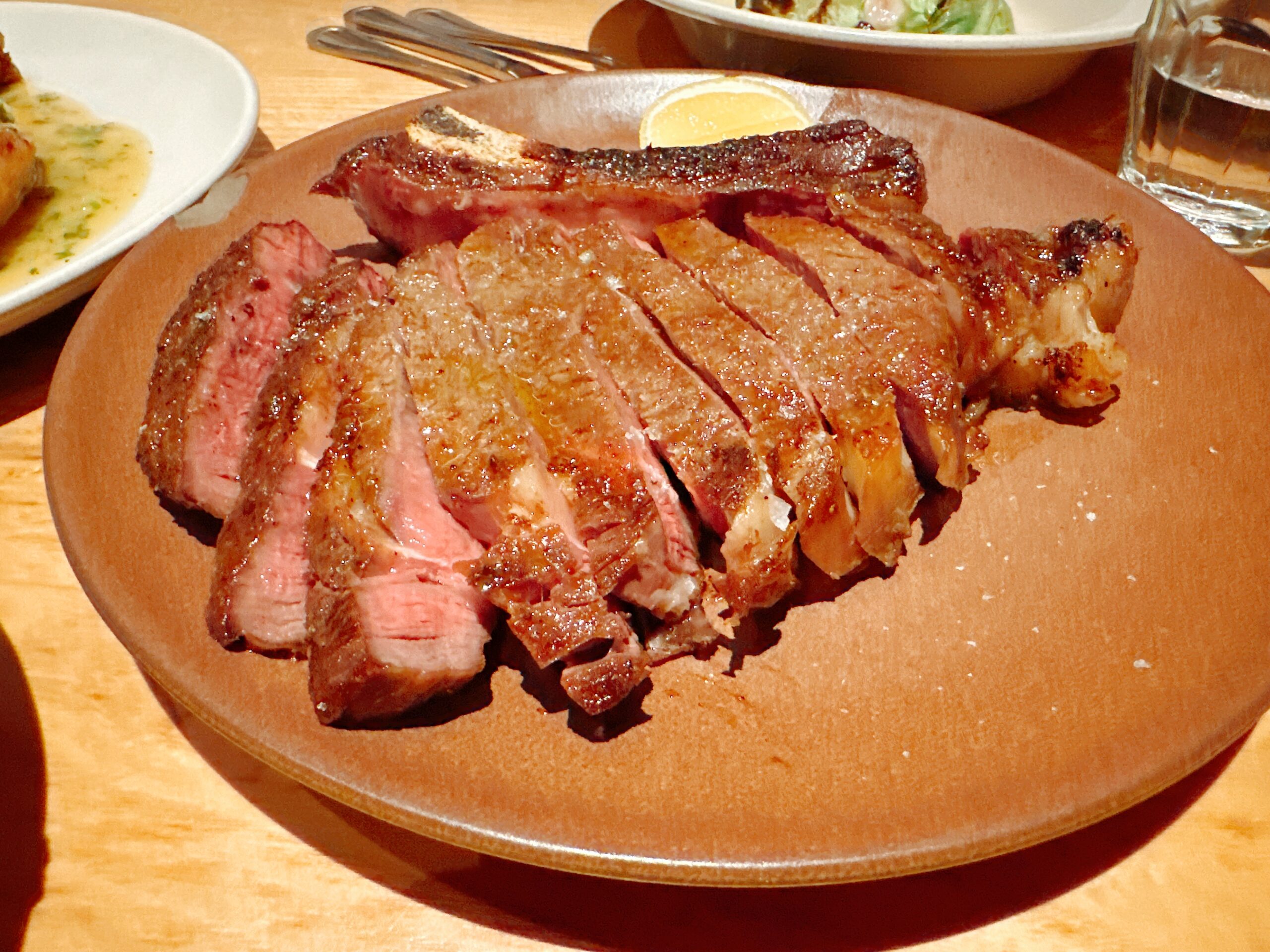 Steak at Rolf and Daughters in Nashville. Photo credit: Robin O'Neal Smith Sliced steak on a plate at Rolf and Daughters in Nashville.