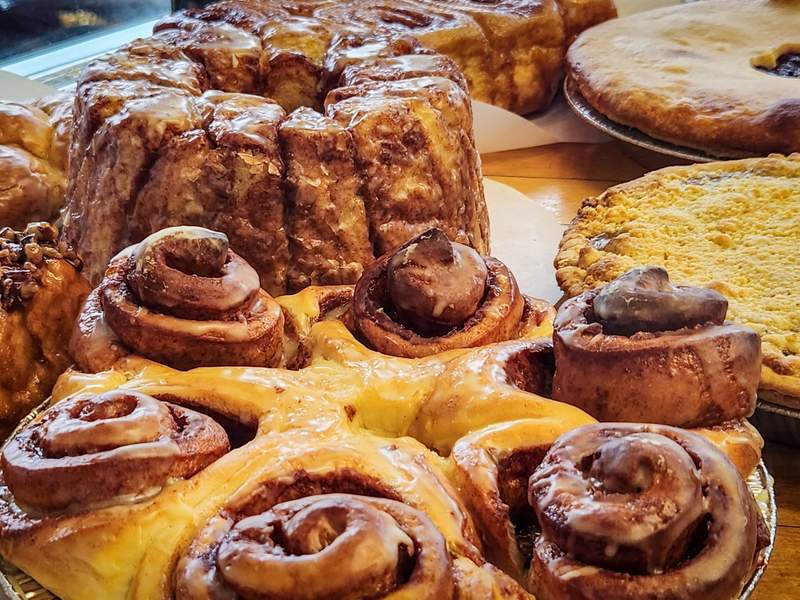 Close-up view of cinnamon rolls, pies and other baked goods