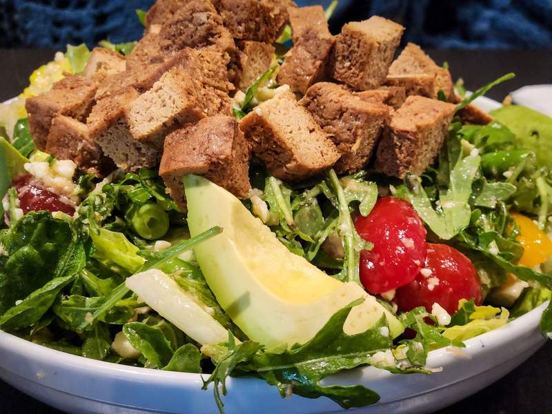Large green salad with avocado, croutons and tomatoes